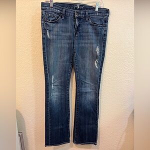 7 For All Mankind Blue Boot Cut Jeans with Distressed Details.